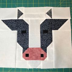 a close up of a piece of fabric with a cow's face on it