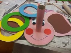 some paper and scissors are laying on top of the table with other crafting supplies