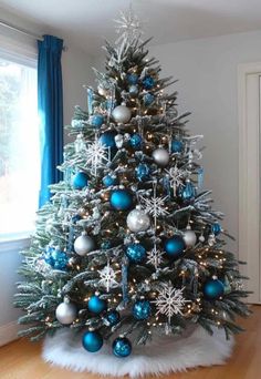 a christmas tree with blue and silver ornaments