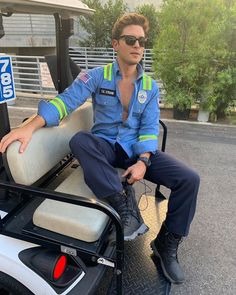 a man sitting on top of a golf cart