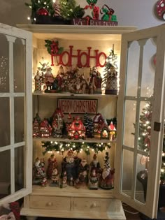 an open cabinet with christmas decorations and lights