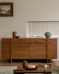 a living room scene with focus on the sideboard and coffee table in the foreground