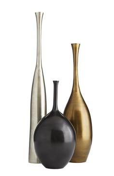 three different colored vases sitting next to each other on a white surface with one black and one gold