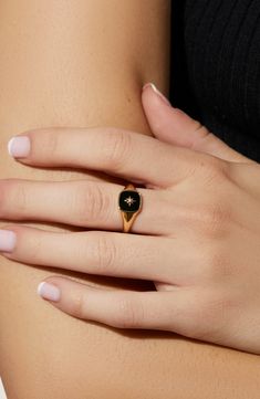 We heard you love bold accents, so we made you this gold signet ring to amp up your seasonal wardrobe. This bold ring is dipped in 14K gold and features an onyx stone beneath a unique star symbol. Wear this gold signet ring with our Amara Mother of Pearl ring for a juxtaposed look. Dipped in 14K gold Features an onyx stone Depth: 3.41mm - 0.13” Weight: 2.24g Crafted In China Onyx Ring Women, Gold And Onyx Ring, Floral Signet Ring, Onyx Gold Ring, Black And Gold Wedding Ring For Women, Local Eclectic Rings Engagement, Gemstone Rings Aesthetic, Gold Alternative Jewelry, Black Onyx Signet Ring