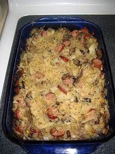 a casserole dish with sausage and rice in it