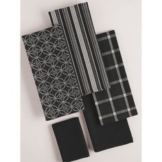 three black and white napkins on top of each other