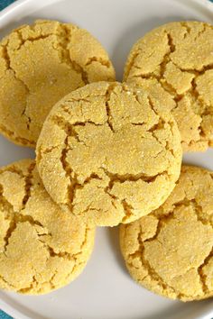 some cookies are on a white plate with blue cloth