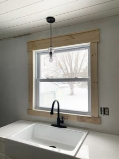 a kitchen sink and window with measurements for the windowsills above it in front of them