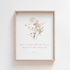 a framed print with pink flowers and the words, she is power among those things