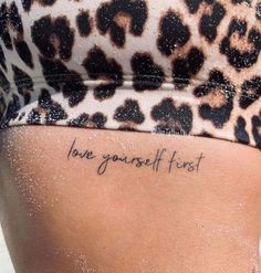 the back of a woman's stomach with an inscription on it that says love yourself first