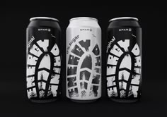 three cans of beer with black and white designs