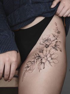 a woman's thigh with flowers on it