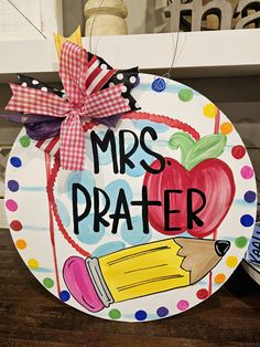 a paper plate with the words mrs prater painted on it and a pencil