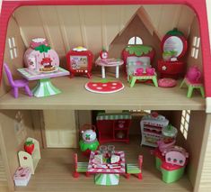 a doll house with furniture and accessories on the inside, including a kitchen area for children to play in