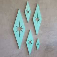 three green geometric shapes on a wall