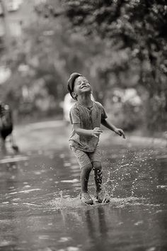 a young boy is playing in the water