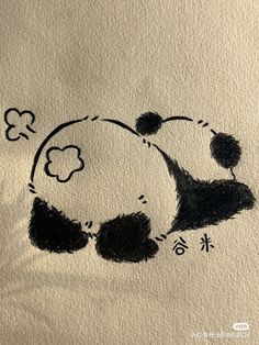 an ink drawing of a panda sleeping on its back with chinese characters written in the background