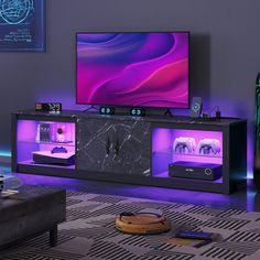 a living room with purple lighting and a flat screen tv on top of a black entertainment center