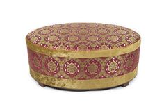 a gold and red ottoman sitting on top of a white floor