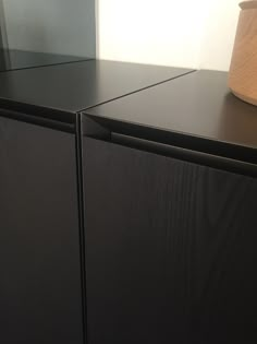 a black cabinet with a wooden lamp on top