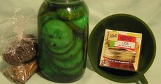 pickles in a jar next to a green plate