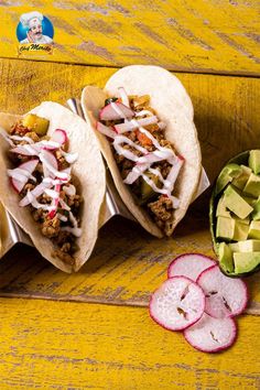 three tacos with toppings and sliced radishes on a yellow table top