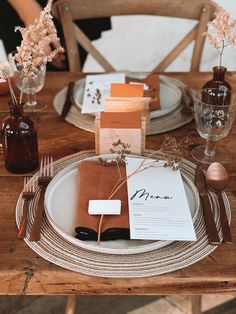 a wooden table topped with plates and napkins