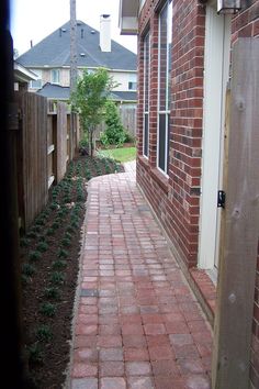 an open door leading to a brick walkway