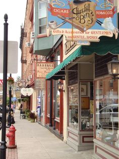 an old fashioned storefront on the side of a city street