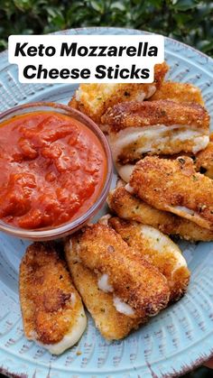 keto mozzarella cheese sticks on a plate with tomato sauce in the middle