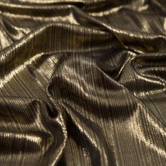 the fabric is shiny and metallic with some folds on it's sides, as well as stripes