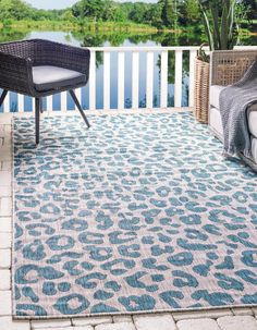 a blue and white area rug with an animal print pattern on the outside of it