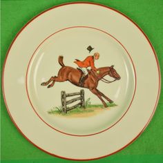 a plate with an image of a man riding a horse on the back of it