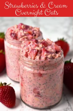 two jars filled with food sitting on top of a table next to some strawberries