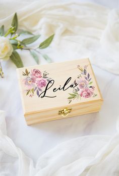 a wooden box with the word leila written in cursive writing on it