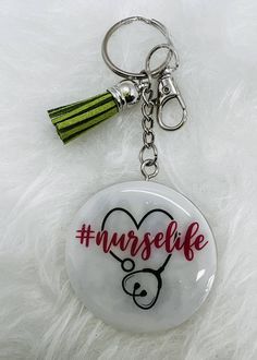 a keychain with a nurse's heart and the words nurselife on it