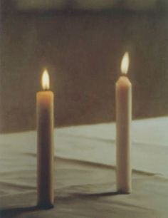 three lit candles sitting on top of a table