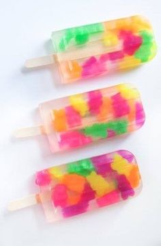 three popsicles with gummy bears on them