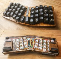 an old computer keyboard is sitting on a wooden table next to it's case