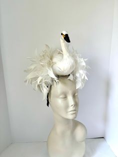 Bird Fascinator- Feather Headband- Swan Lake-   Derby- White Feather Headband- Diner in Blanc Hello,            This fascinator is perfect to add whimsical fun to any occasion. You'll be the life of the party with this great conversation piece Comes in 2 sizes. This MEDIUM SWAN feather fascinator has a white swan that is about 7" high with a puff of coque feathers.  It has great movement. It's not a real bird, it's Styrofoam covered with feathers and is very light. The coque feathers are about 6-8", placed on a straw circle and then placed on a 1/8" satin headband. The covered headband is stainless steel and is adjustable to fit any head size. I call her Princess Odette. -------------------------------- LARGE SIZE in press : https://etsy.me/3RZEslT   --------------------------------------- Whimsical Fitted Costume Headpiece For Races, Fitted Whimsical Costume Hat For Races, Fitted Whimsical Hat For Races, Feathered Headbands, Bird Fascinator, Princess Odette, Swan Costume, Yellow Fascinator, White Fascinator