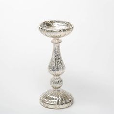 a silver candle holder on a white background