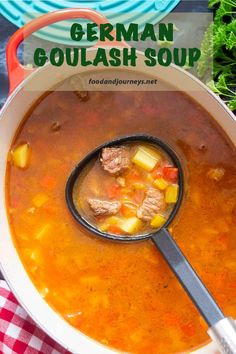 german goulash soup in a pot with a ladle full of meat and vegetables