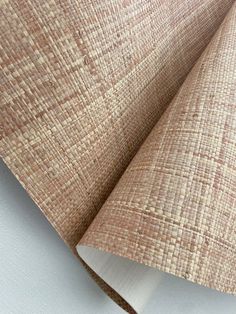 a close up view of the fabric on top of a white surface with a brown and tan pattern