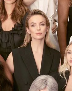 several women in black and white are posing for the camera