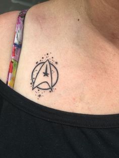 a woman with a star trek tattoo on her chest