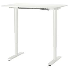 a white computer desk sitting on top of a table