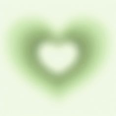 a blurry image of a heart shaped object on a white background with green highlights