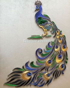 the peacock is made out of metal and has blue, green, yellow and white feathers