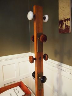 a wooden door handle with three balls on it