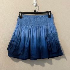 Excellent Condition Blue Ombr Skirt With Exterior Pockets, A Ruched Waist, And Flowy Skirt. Length: 15.5” Waist: 10”-18” (Elastic) My Poshmark Closet Is A Curated Boutique For Anyone Who Wants To Make A Statement With Their Style. We Offer Brand New, Like New, And Pre-Loved Clothing. On Poshmark, We Offer You Clothes That Will Always Be One Of A Kind - Just For You! Our Prices Are Competitive So Shop Today And Find Your Perfect Look! Additionally, Please Reach Out If You Have Any Questions About Summer Blue Gathered Skirt, Blue Stretch Summer Skirt, Blue Mini Skirt With Gathered Detail, Blue Gathered Mini Skirt, Blue Mini Length Gathered Skirt, Blue Stretch Gathered Skirt, Blue Summer Skirt With Elastic Waistband, Blue Tiered Mini Skirt With Elastic Waistband, Blue Short Summer Skirt